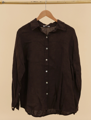 Brown shirt on a hanger against a beige background