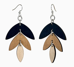 Pair of earrings with layered wooden leaves on a white background