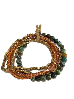 Set of beaded bracelets with orange, green, and gold colors on a white background