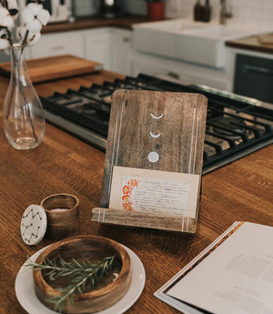 Wooden card holder with phases of the moon on a kitchen counter