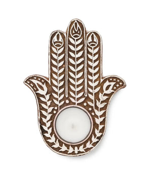 Decorative Hamsa hand with a candle holder on a white background