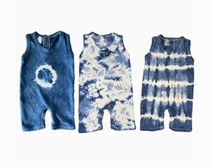 Three tie-dye baby rompers in blue and white on a white background