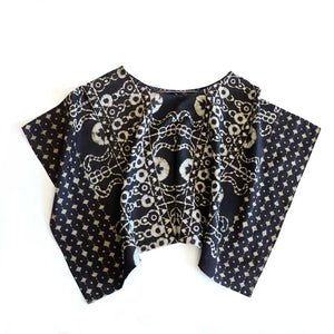 Black top with white patterns on a white background