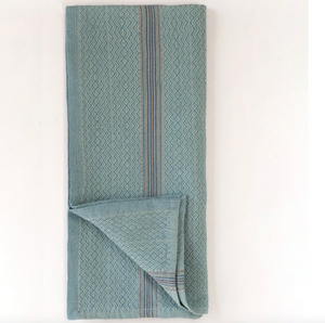 Folded blue napkin with striped pattern on a white background