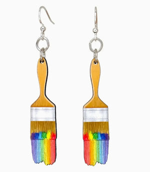 Earrings shaped like paint brushes with rainbow bristles on a white background