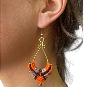 Close-up of an ear wearing a colorful beaded earring.