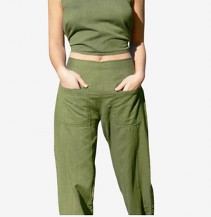 Person wearing green pants and a cropped top on a white background