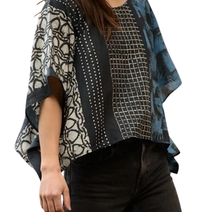Person wearing a patterned top with a white background