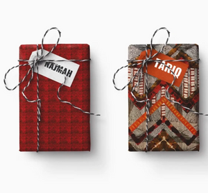 Two gift boxes with decorative ribbons and tags on a white background