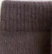 Close-up of a textured dark berry colored fabric swatch