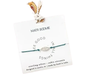 Bracelet with eye charm on a branded card on a white background