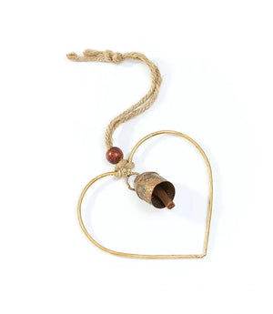Heart-shaped gold pendant with a wooden bead on a white background
