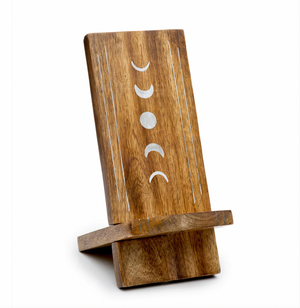 Wooden phone stand with moon phase design on a white background