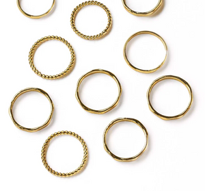 Gold rings with various designs on a white background