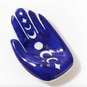 Blue decorative item shaped like a hand with white patterns on a white background