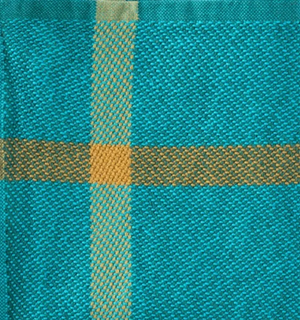 Close-up of a woven fabric with blue and green pattern