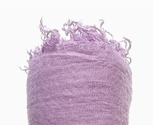Purple textured fabric with frayed edges on a white background