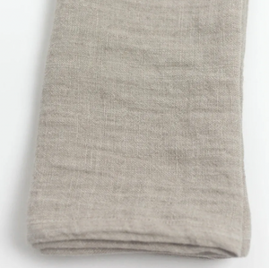 Folded gray fabric napkin on a white background