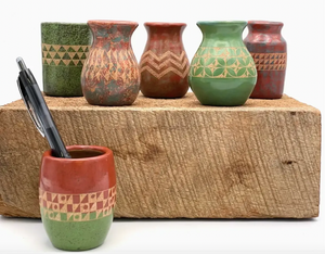 Set of ceramic vases with geometric patterns on a wooden block