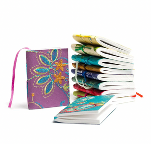 Colorful notebooks with floral designs on a white background