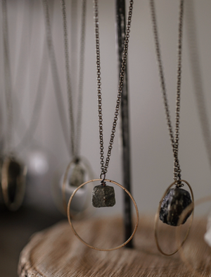 Necklaces with pendant stones on a neutral background