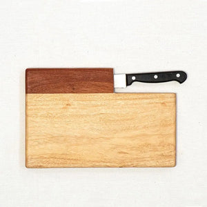 Wooden cutting board with a knife on a white background