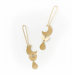 Gold earrings with a moon phase design on a white background