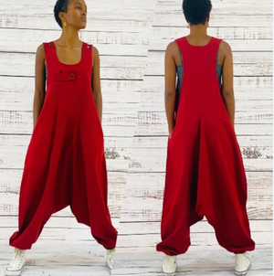 Baggy red overalls worn by a person on a wooden background