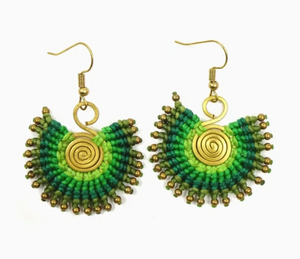 Green and gold beaded earrings on a white background