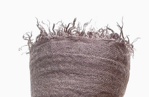 Textured brown fabric with frayed edges on a white background