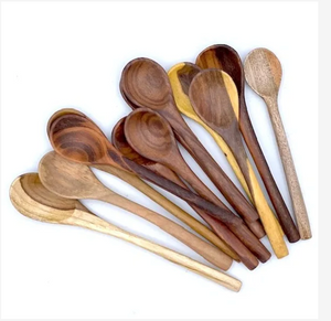 Set of wooden spoons in various shades on a white background