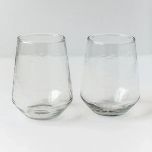 Two clear glass tumblers on a white background