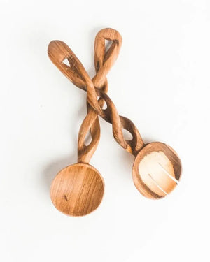 Twisted wooden spoon and fork on a white background