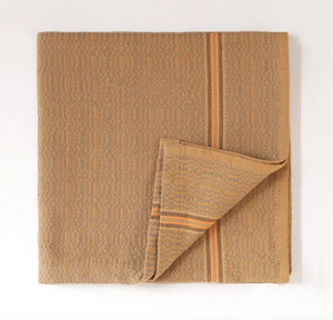 Folded yellow towel with a subtle pattern on a white background