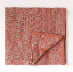 Folded pink patterned towel on a white background