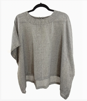 Gray boxy top on a hanger against a white background