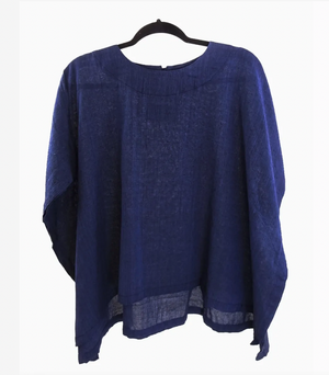 Blue boxy top on a hanger against a white background