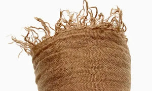 Brown textured fabric with frayed edges on a white background