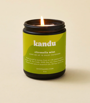 Kandu citronella mint candle with a green label on a beige background