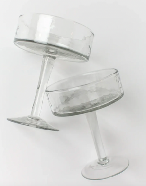 Two clear glass stemware pieces on a white background
