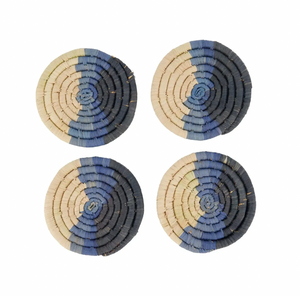 Four round woven coasters with blue and beige pattern on a white background
