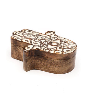 Wooden box with intricate carvings on a white background