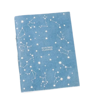 Blue monthly planner with star and constellation pattern on a white background