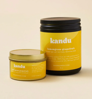 Two yellow jars with lids and labeled 'kandu' on a beige background