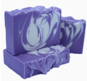 Purple and white swirled soap bars on a white background
