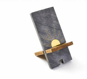 Phone stand with sun design on a white background
