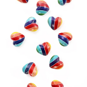 Rainbow-striped, heart-shaped figurines on a white background