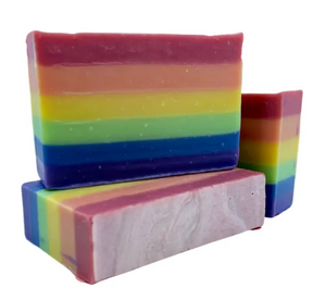 Three rainbow-colored soap bars on a white background