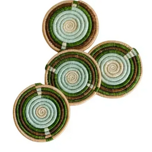 Set of four multicolor round woven coasters with green and brown patterns on a white background