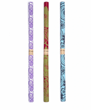 Three colorful rolls of gift wrap with intricate patterns on a white background